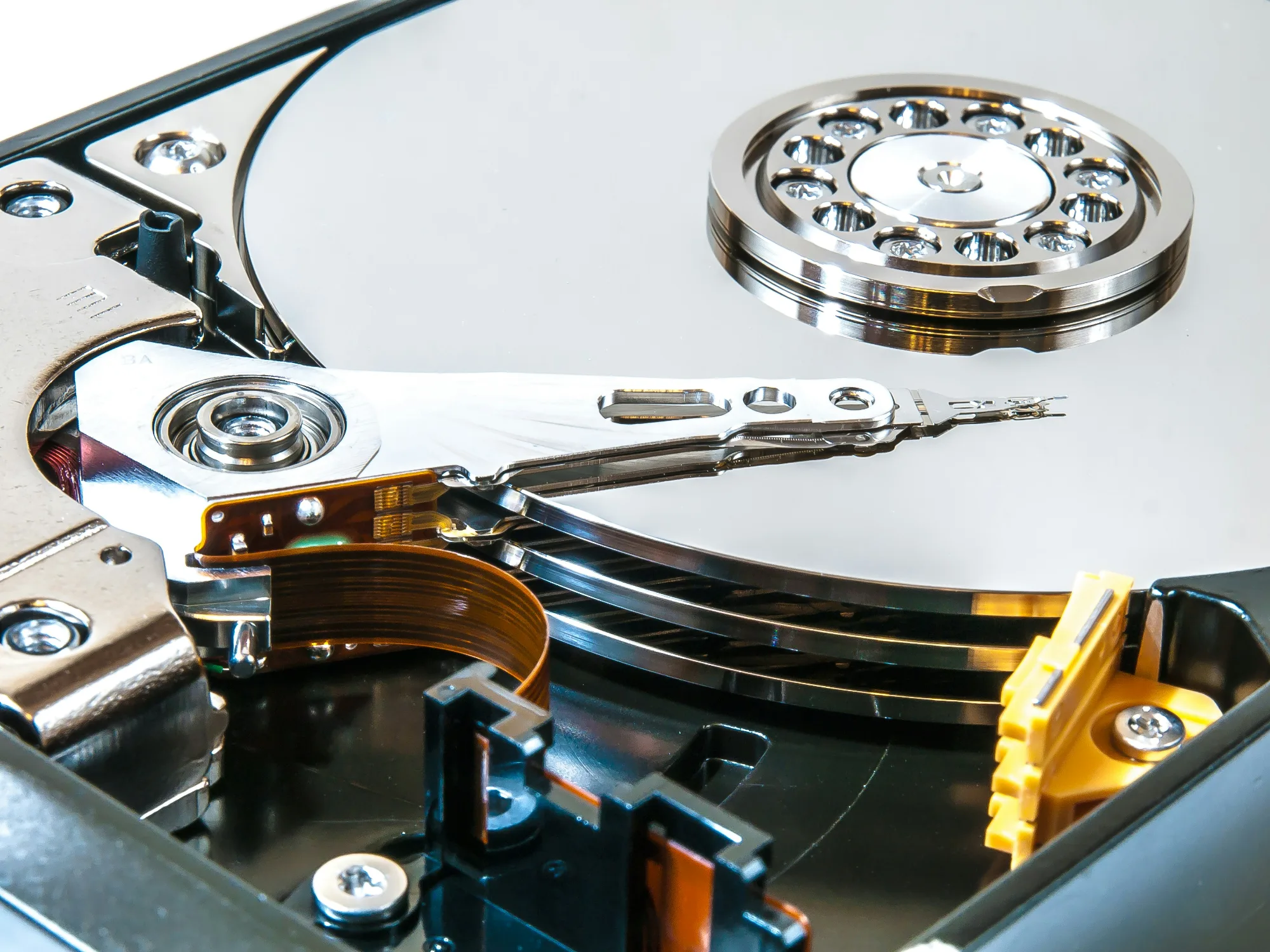 Opened hard drive showing the platter and read arm